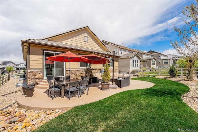 3480 Mount Powell Dr, Broomfield, CO 80023 - rear view of property featuring a lawn, a patio, outdoor lounge area, and fence