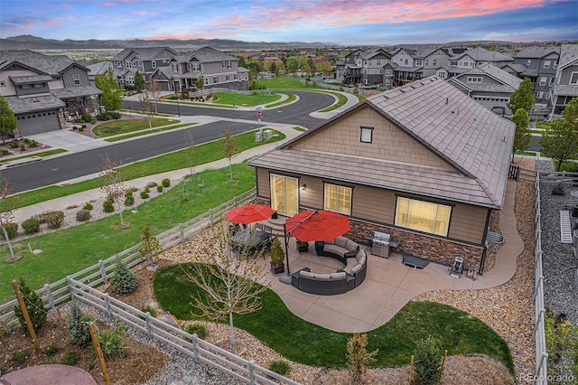 3480 Mount Powell Dr, Broomfield, CO 80023 - exterior space featuring an outdoor hangout area, a patio area, stone siding, and a residential view