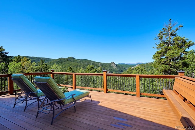 wooden terrace with a mountain view and a wooded view