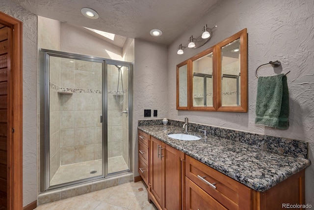 bathroom with recessed lighting, a textured wall, a stall shower, vanity, and a textured ceiling