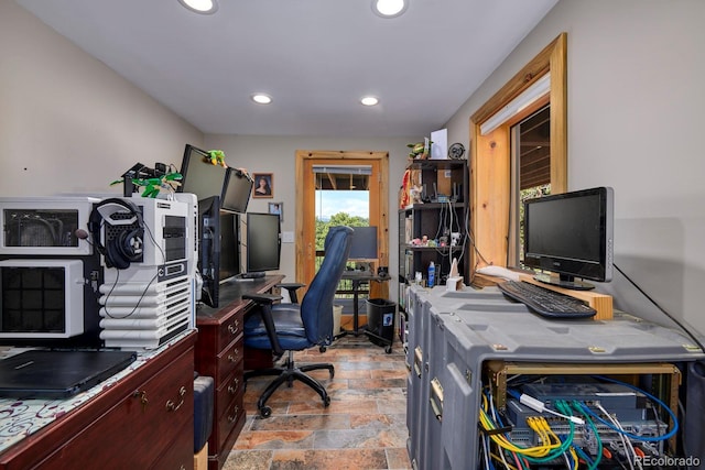 office space featuring stone finish flooring and recessed lighting