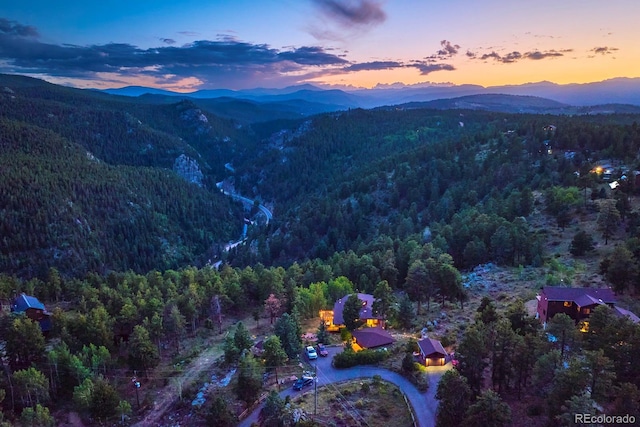 aerial view with a wooded view and a mountain view