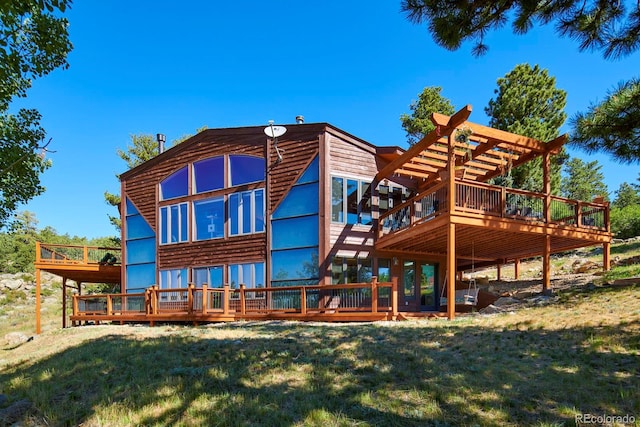 rear view of property with a yard and a deck