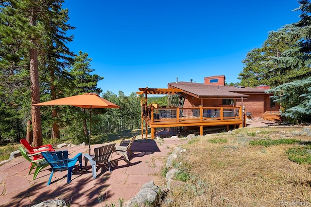 rear view of property featuring a deck and a patio area