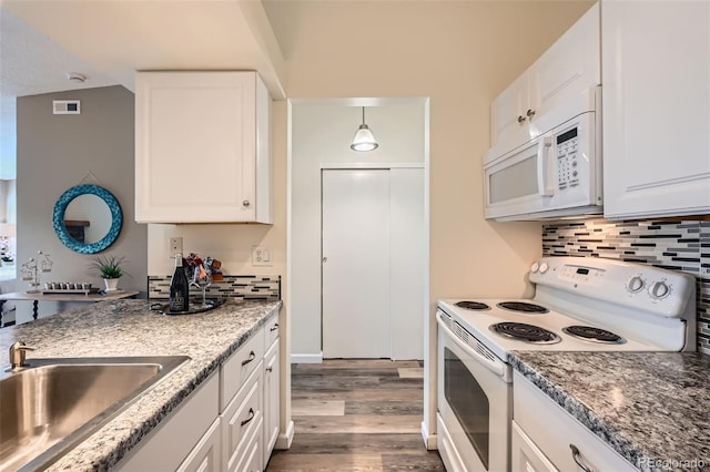 4285 S Salida Way Unit 17, Aurora, CO 80013 - kitchen featuring white appliances, a sink, dark wood finished floors, and backsplash