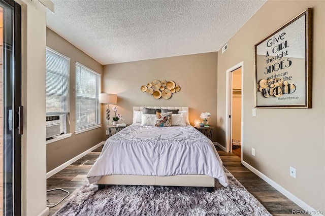 4285 S Salida Way Unit 17, Aurora, CO 80013 - bedroom featuring wood finished floors, a textured ceiling, cooling unit, and baseboards