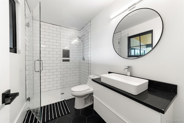 bathroom with an enclosed shower, vanity, tile patterned floors, and toilet