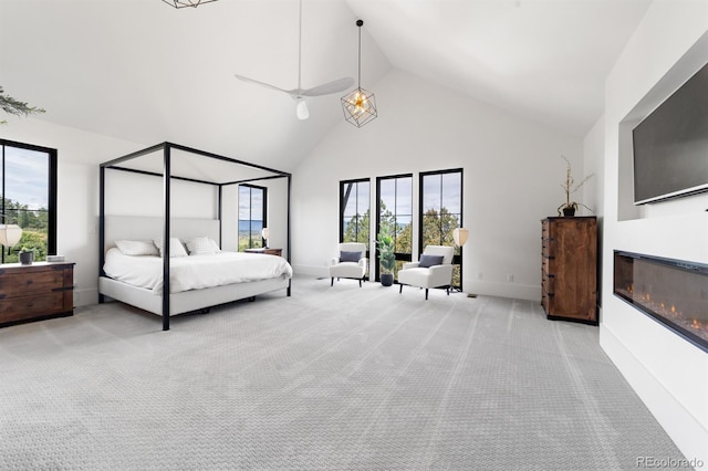 bedroom with light carpet and high vaulted ceiling