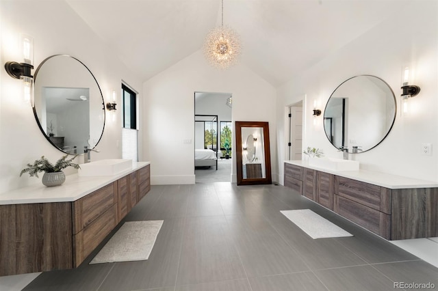 bathroom featuring vanity, an inviting chandelier, and high vaulted ceiling