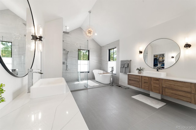 bathroom with lofted ceiling, vanity, and plus walk in shower