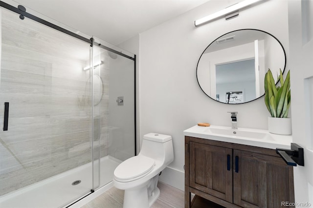 bathroom featuring vanity, an enclosed shower, and toilet