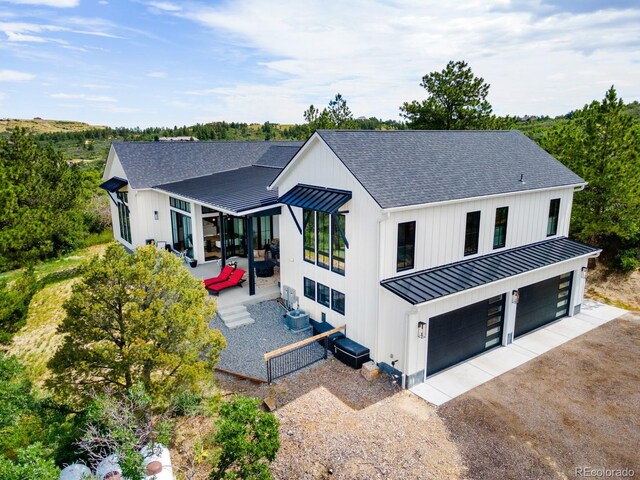 view of front of home with cooling unit and a garage