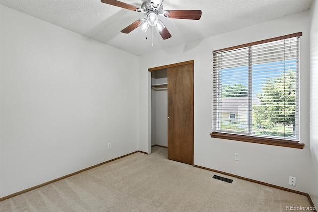 3973 S Joplin Way, Aurora, CO 80013 - unfurnished bedroom featuring light colored carpet, a textured ceiling, a closet, and a ceiling fan