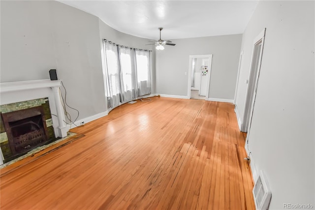 unfurnished living room with ceiling fan and light hardwood / wood-style flooring