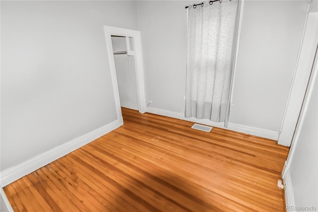 unfurnished bedroom featuring hardwood / wood-style floors