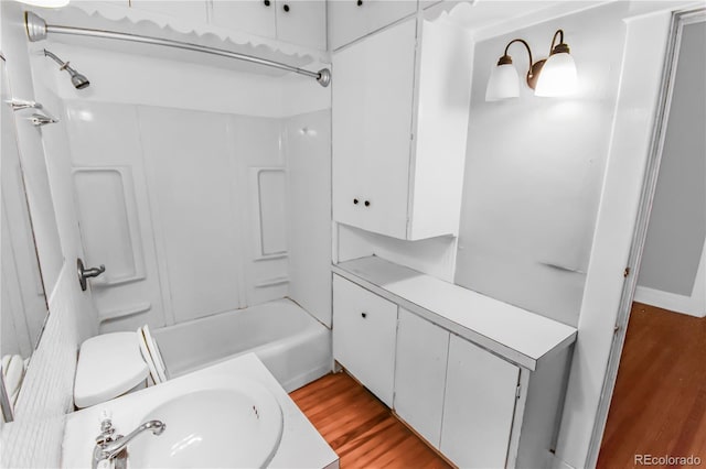 full bathroom featuring shower / tub combination, toilet, hardwood / wood-style floors, and sink