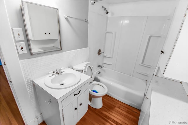 full bathroom featuring shower / washtub combination, toilet, wood-type flooring, and vanity