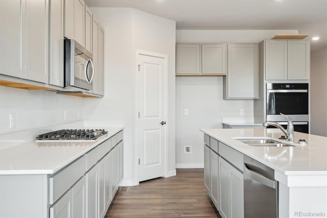 1321 Loraine Cir N, Lafayette, CO 80026 - kitchen featuring stainless steel appliances, an island with sink, a sink, and light countertops