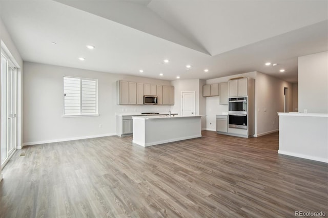1321 Loraine Cir N, Lafayette, CO 80026 - kitchen featuring stainless steel appliances, gray cabinets, light countertops, and an island with sink