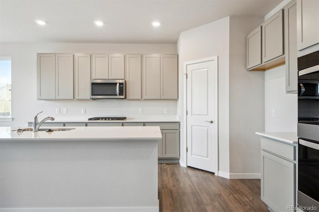 1321 Loraine Cir N, Lafayette, CO 80026 - kitchen featuring dark wood-type flooring, stainless steel appliances, light countertops, gray cabinetry, and a sink