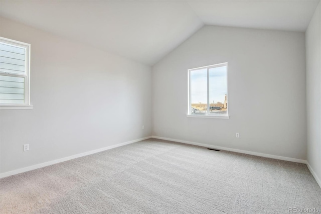 1321 Loraine Cir N, Lafayette, CO 80026 - carpeted spare room featuring baseboards, visible vents, and vaulted ceiling