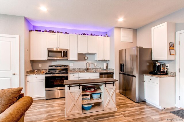 262 S 4th Ct, Deer Trail, CO 80105 - kitchen with appliances with stainless steel finishes, light wood finished floors, white cabinets, light stone counters, and recessed lighting