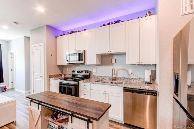 262 S 4th Ct, Deer Trail, CO 80105 - kitchen featuring stainless steel appliances, light wood-style flooring, wood counters, white cabinetry, and recessed lighting