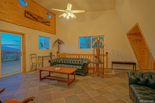 living room with high vaulted ceiling, ceiling fan, and tile floors