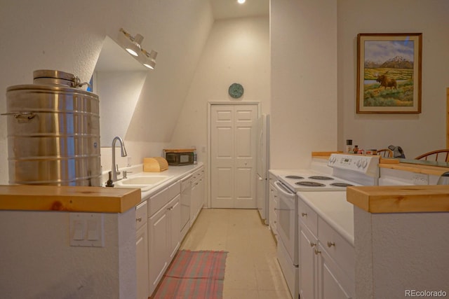 bathroom featuring sink, lofted ceiling, and tile flooring