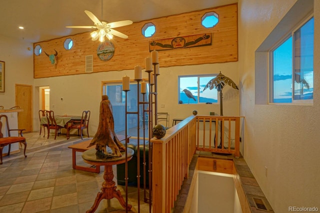 interior space with high vaulted ceiling and tile flooring