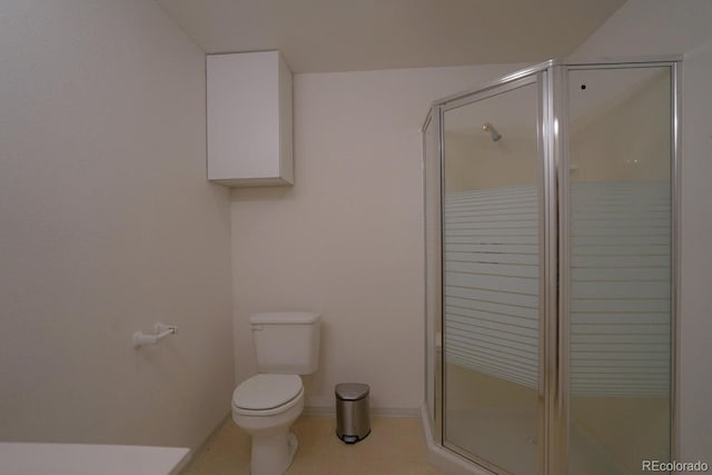 bathroom featuring a shower with door, tile flooring, and toilet