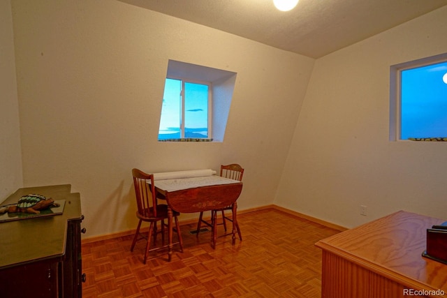 dining area with parquet flooring