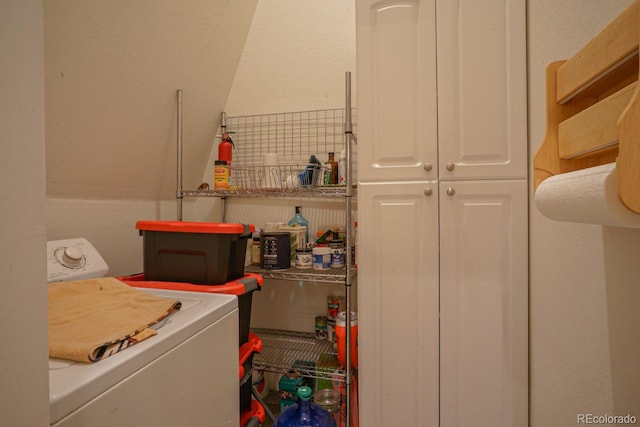 washroom featuring cabinets and washer / dryer