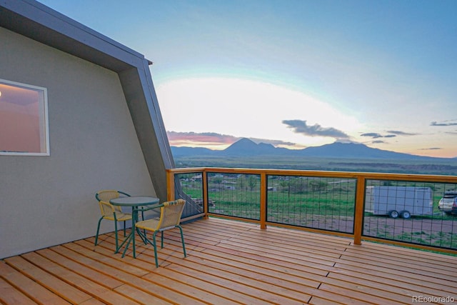 deck at dusk with a mountain view