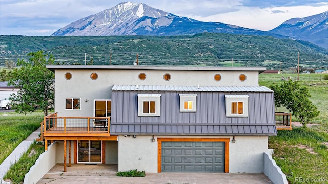 view of front of property with a garage and a mountain view