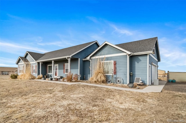 253 E 8th Ave, Byers, CO 80103 - ranch-style house with an attached garage, roof with shingles, and covered porch