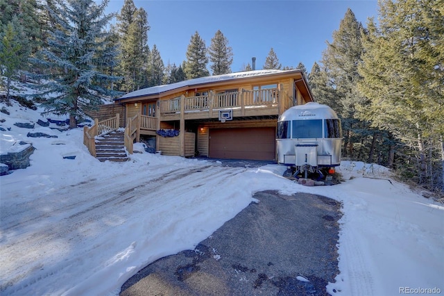 view of front facade with a wooden deck and a garage