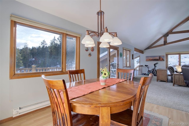 dining room featuring baseboard heating, a healthy amount of sunlight, vaulted ceiling, and light wood-type flooring