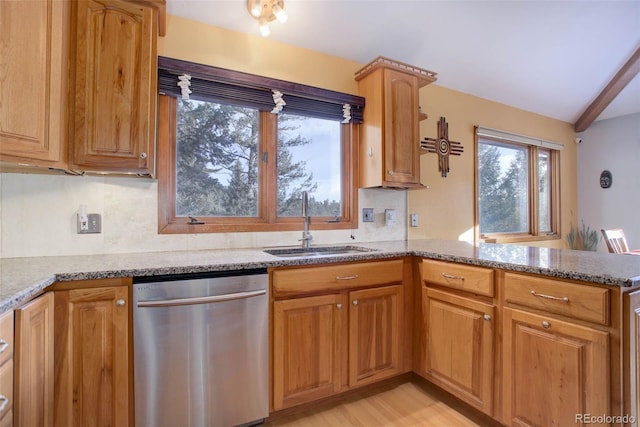 kitchen featuring sink, light hardwood / wood-style flooring, dishwasher, light stone counters, and kitchen peninsula