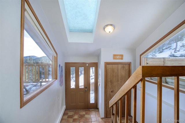 foyer entrance with a mountain view and a healthy amount of sunlight