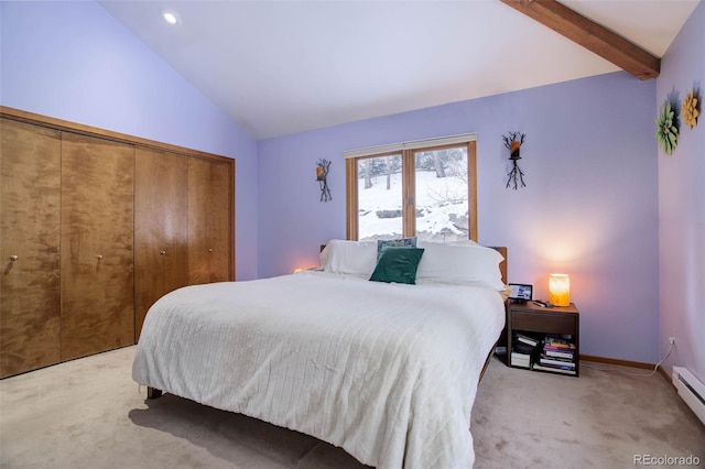 carpeted bedroom with lofted ceiling with beams, a closet, and a baseboard heating unit