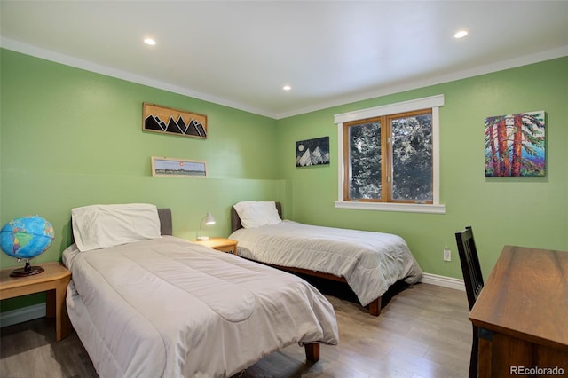 bedroom with crown molding and light hardwood / wood-style floors