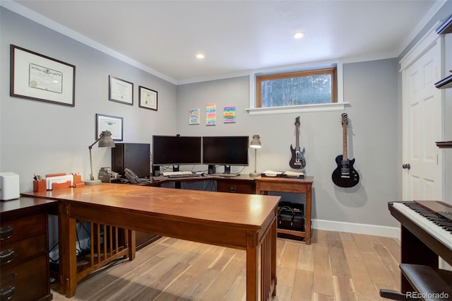 office area with ornamental molding and light hardwood / wood-style floors