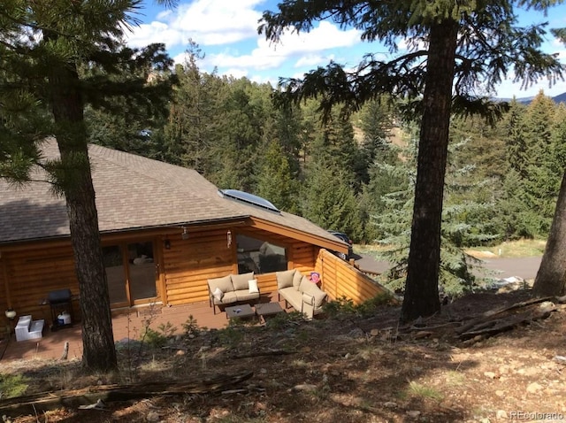 back of property featuring solar panels