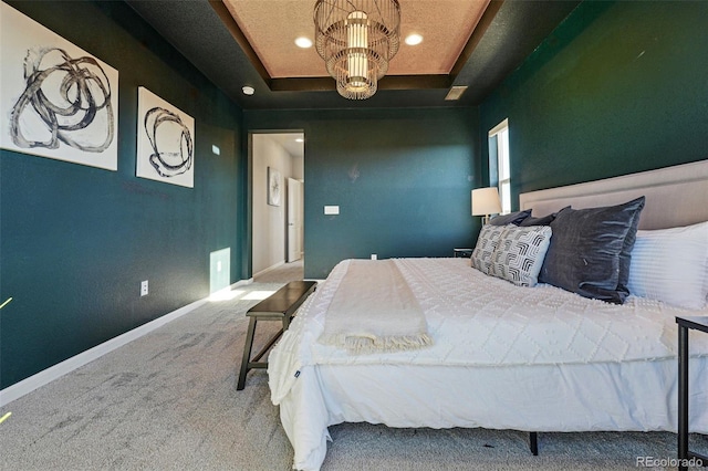 carpeted bedroom featuring an inviting chandelier, a raised ceiling, baseboards, and recessed lighting
