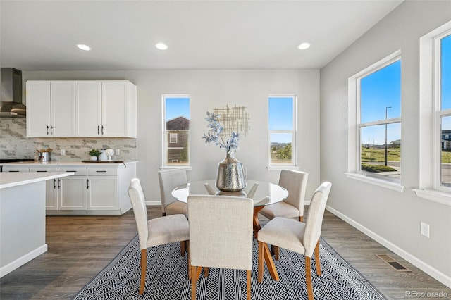 dining room featuring baseboards, dark wood-style floors, and recessed lighting