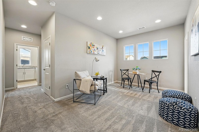 sitting room featuring recessed lighting, plenty of natural light, and carpet floors