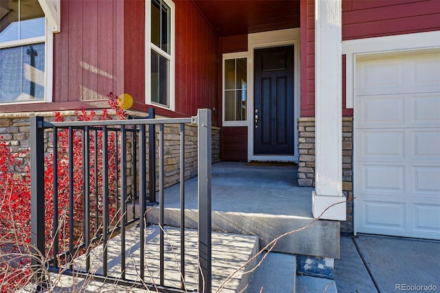 entrance to property with stone siding and a porch