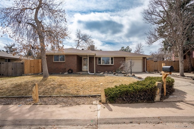 ranch-style house featuring driveway, a garage, fence, and brick siding