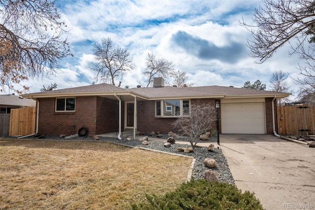 ranch-style home with brick siding, fence, and an attached garage